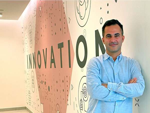 Hamed Farhadian in front of a wall reading “Innovation”