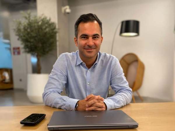 Hamed Farhadian at a meeting table with his laptop