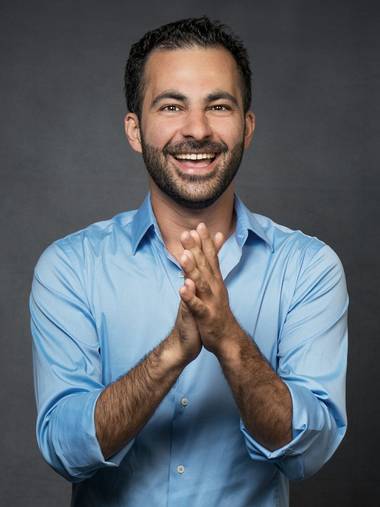 Hamed Farhadian laughing with his hands pressed together